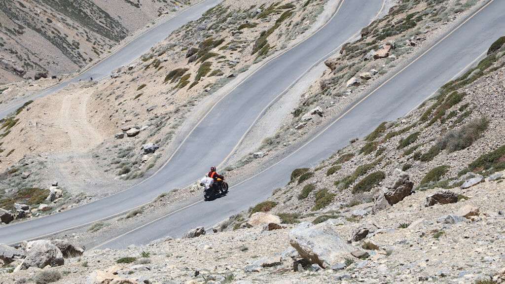 Person riding motorcycle loaded with bags