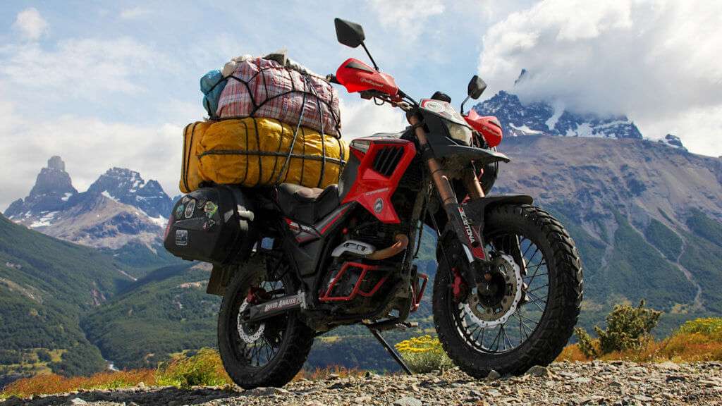 Red motorcycle loaded with bags