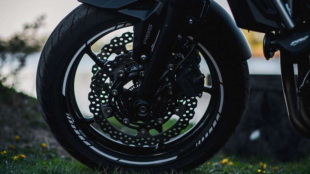 Front motorcycle tire on a black motorcycle