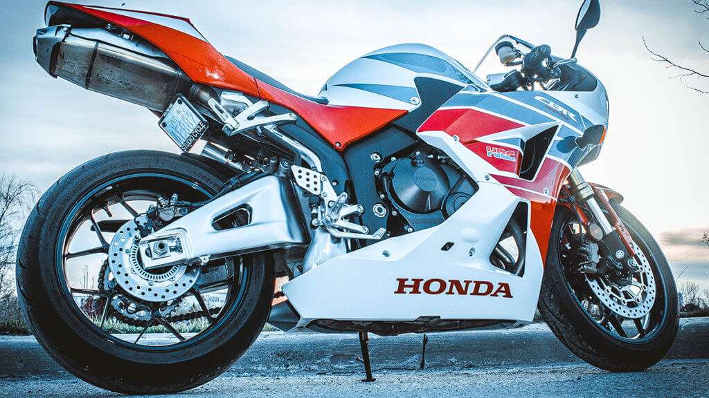 A white and red Honda CBR from the ground level