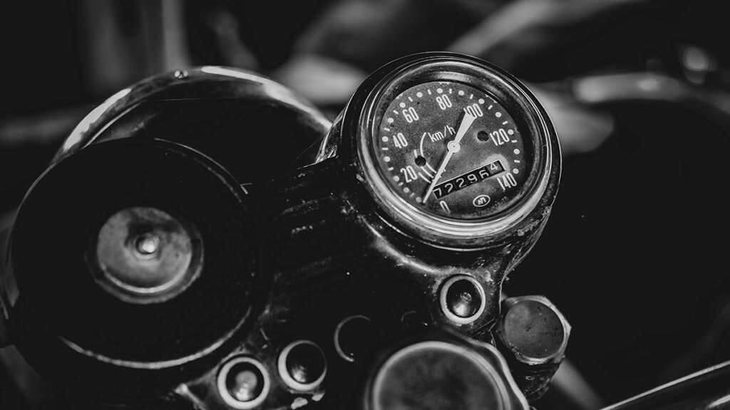 Black and white close-up of a motorcycle speedometer