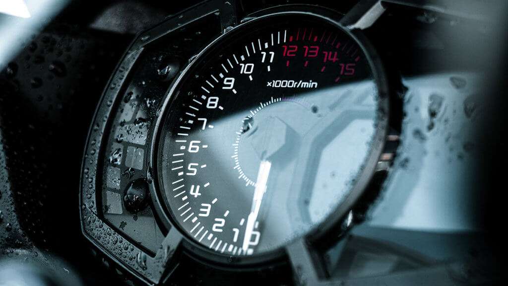 Close-up of a motorcycle tachometer a bit wet 