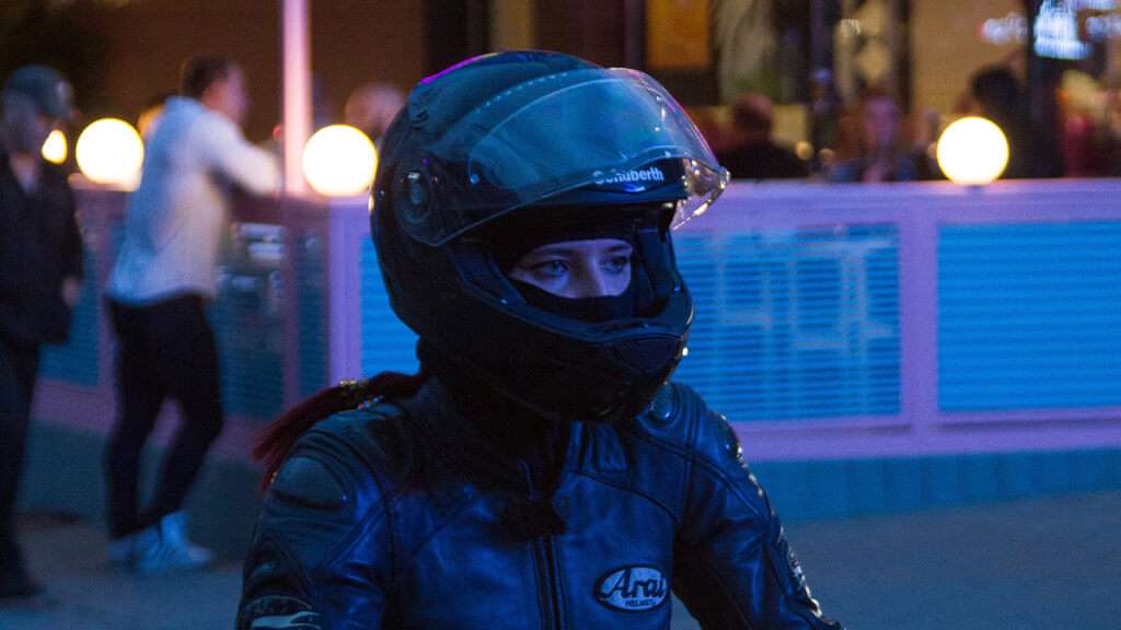 Woman with full-face helmet and a black jacket 