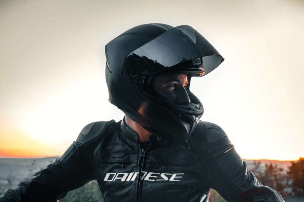 Man wearing a black motorcycle helmet