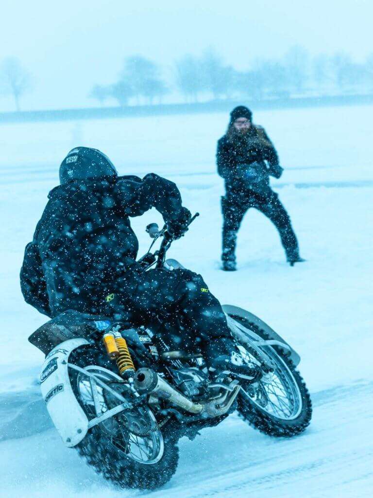 Person riding a motorcycle in the snow