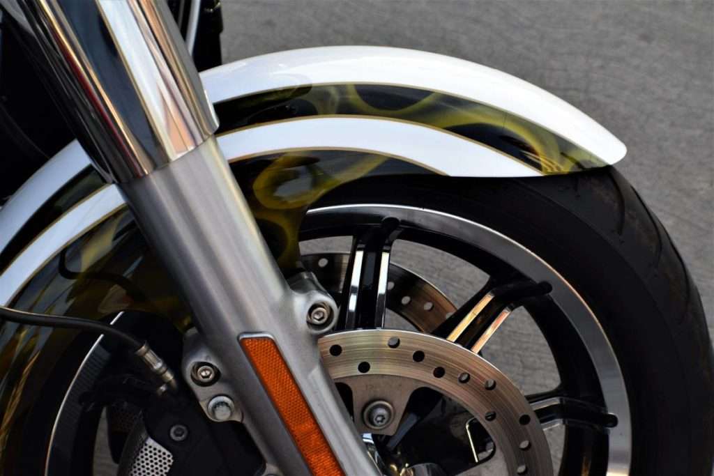 Close-up of a motorcycle front wheel and fork