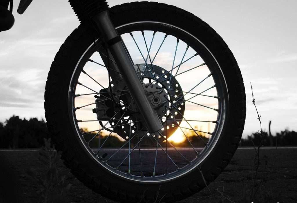 Motorcycle front wheel at sunset