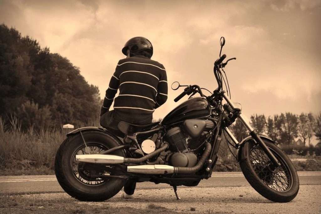 Man sitting on a parked motorcycle