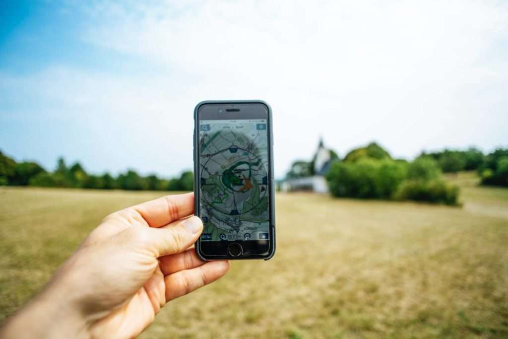 Hand holding a phone with a GPS map on it