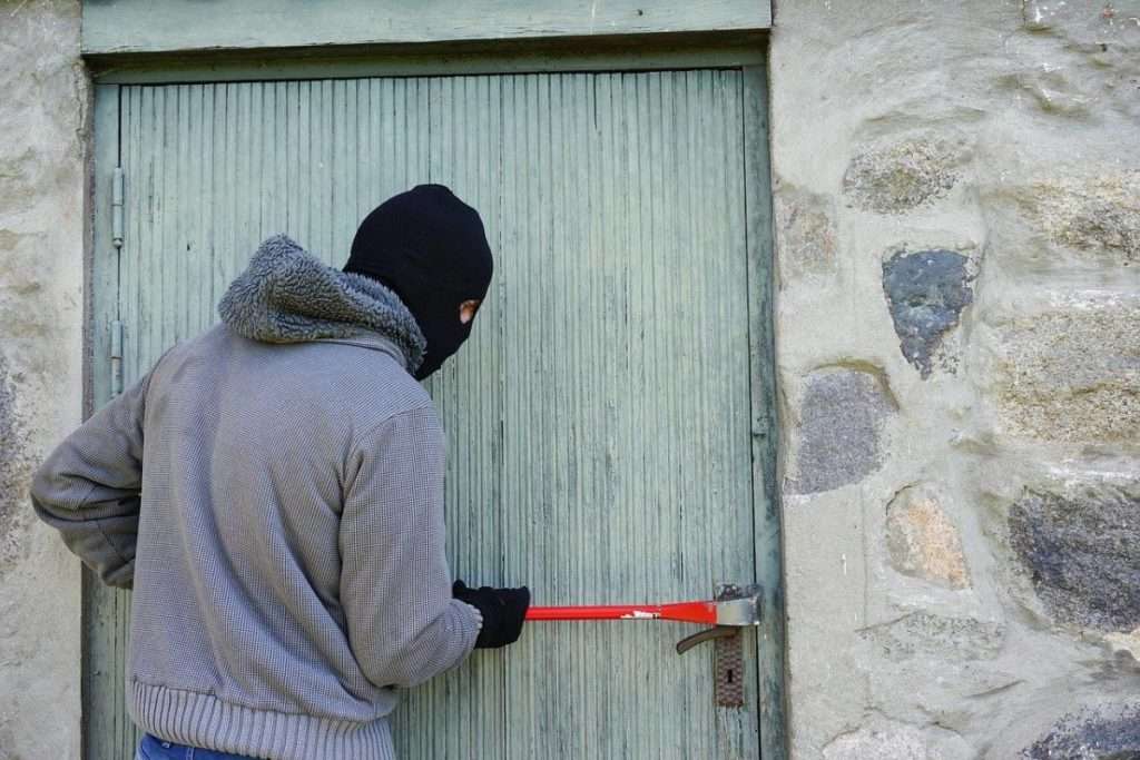 Burglar breaking into a door