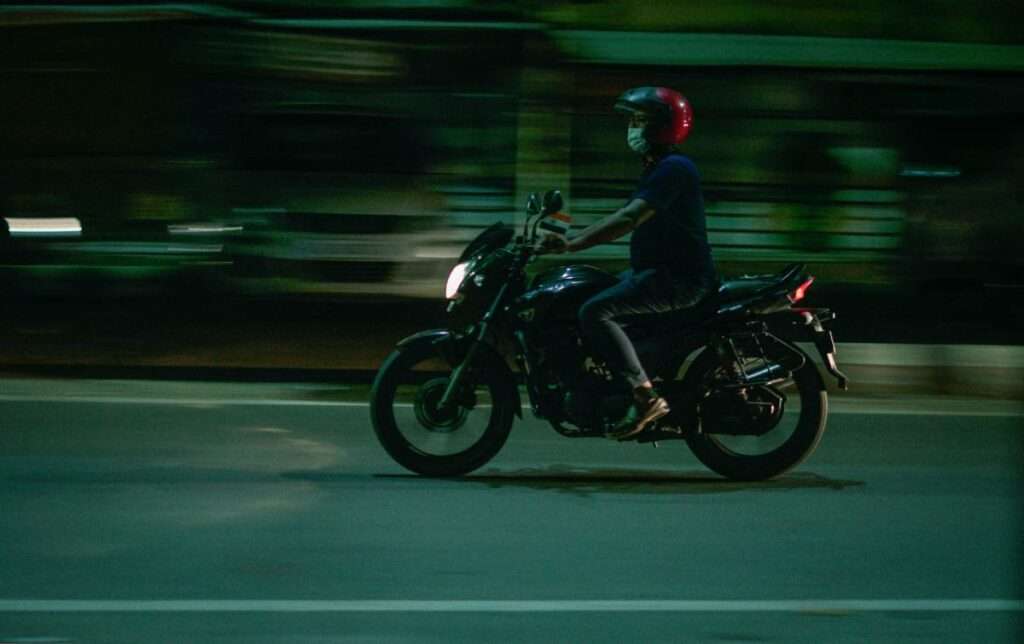 Person riding a motorcycle at night