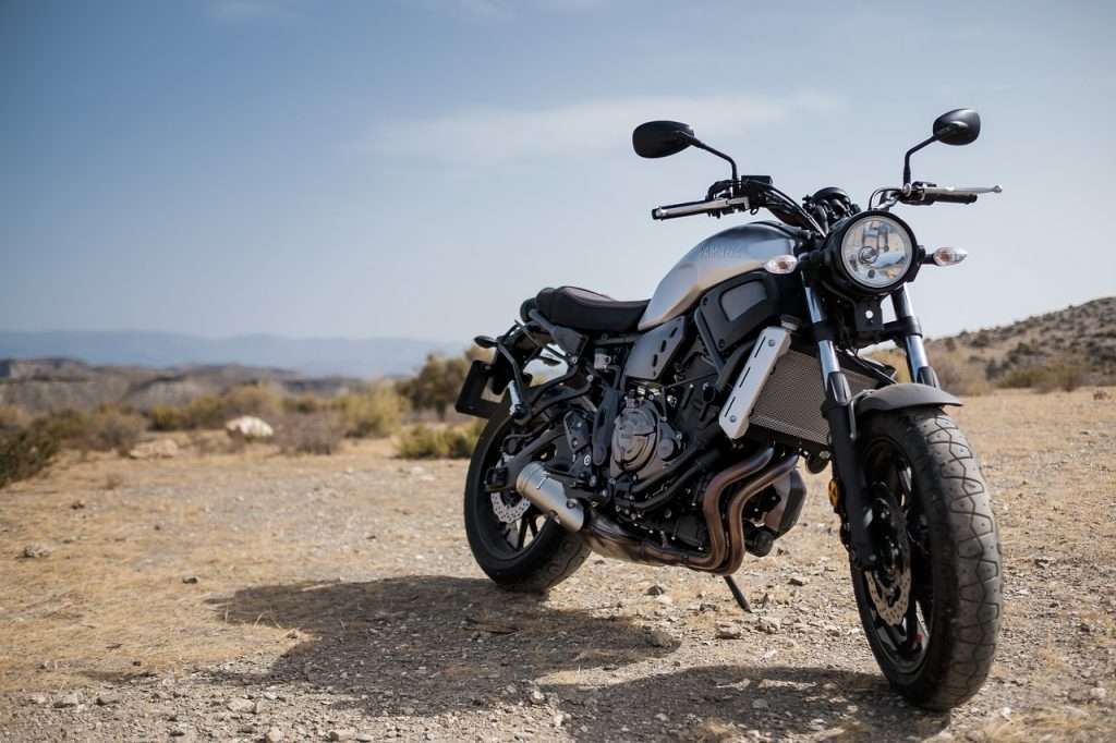 A grey motorcycle on a dirt road