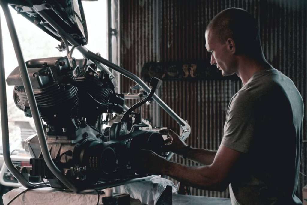 Man working on a motorcycle engine